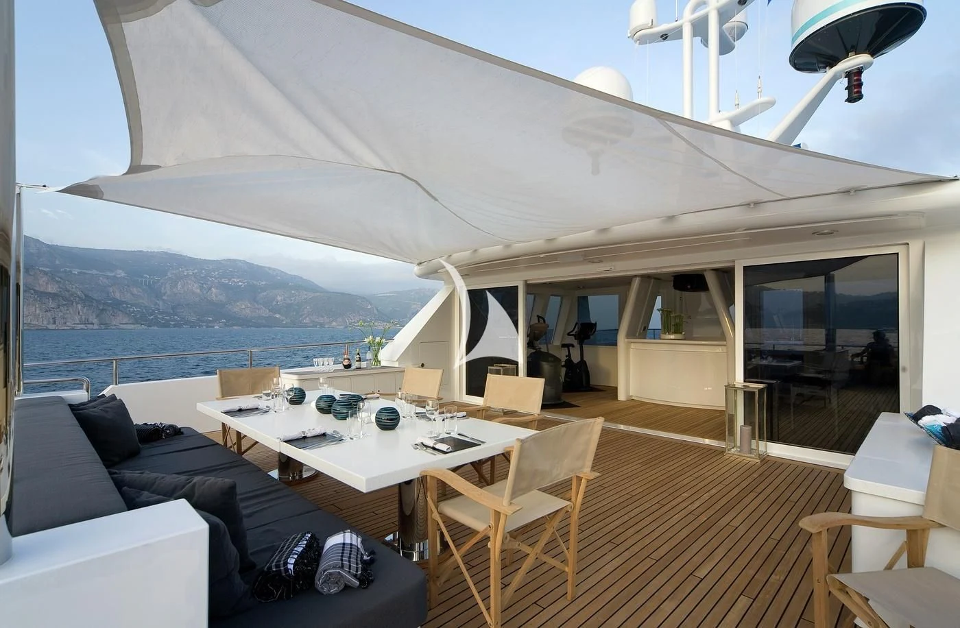 a room with a couch and a table and chairs aboard CYAN Yacht for Sale