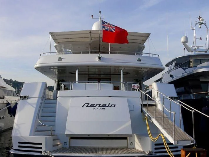 a large white boat with a flag on the front aboard CYAN Yacht for Sale