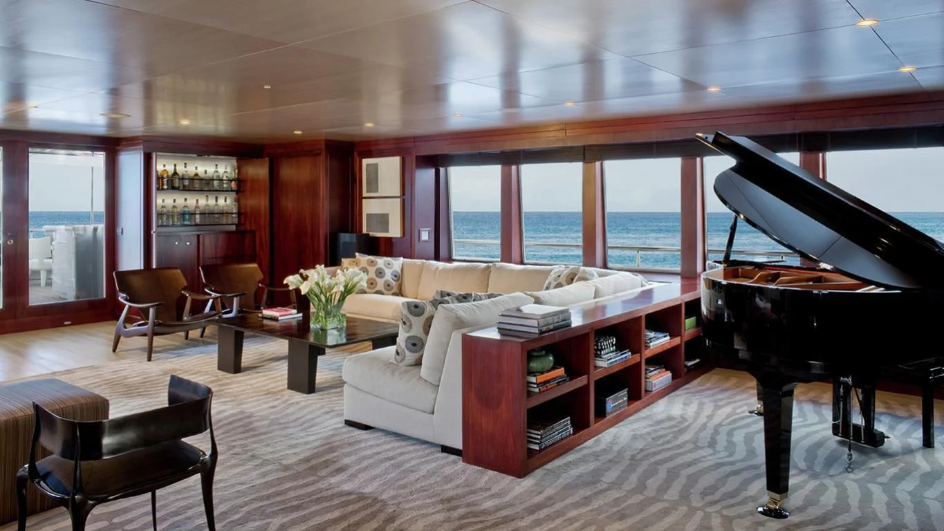 a living room with a piano and a piano aboard CYAN Yacht for Sale