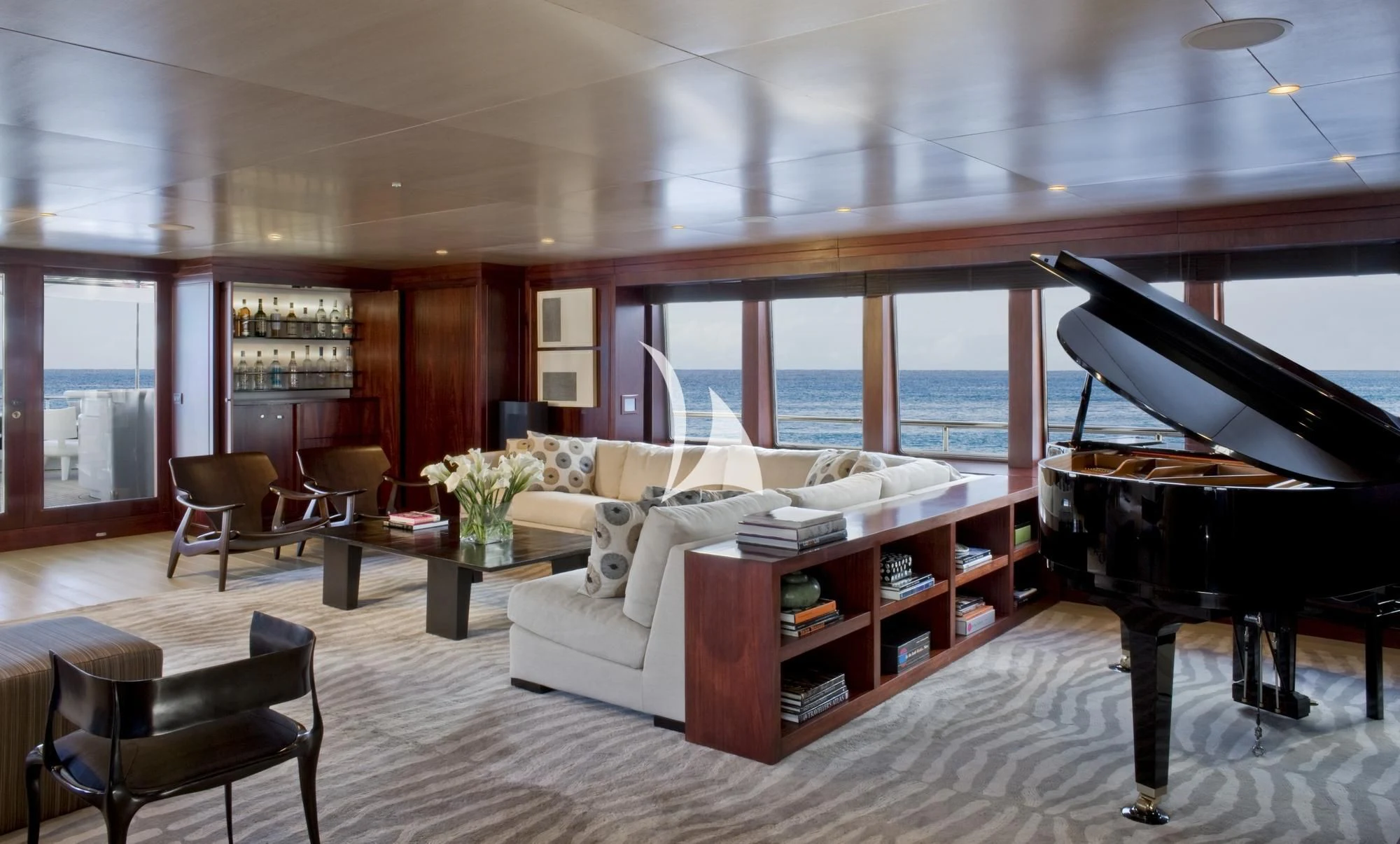 a living room with a piano and a piano aboard CYAN Yacht for Sale