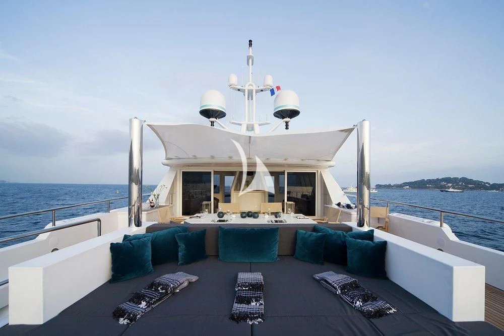 a large white boat on a body of water aboard CYAN Yacht for Sale