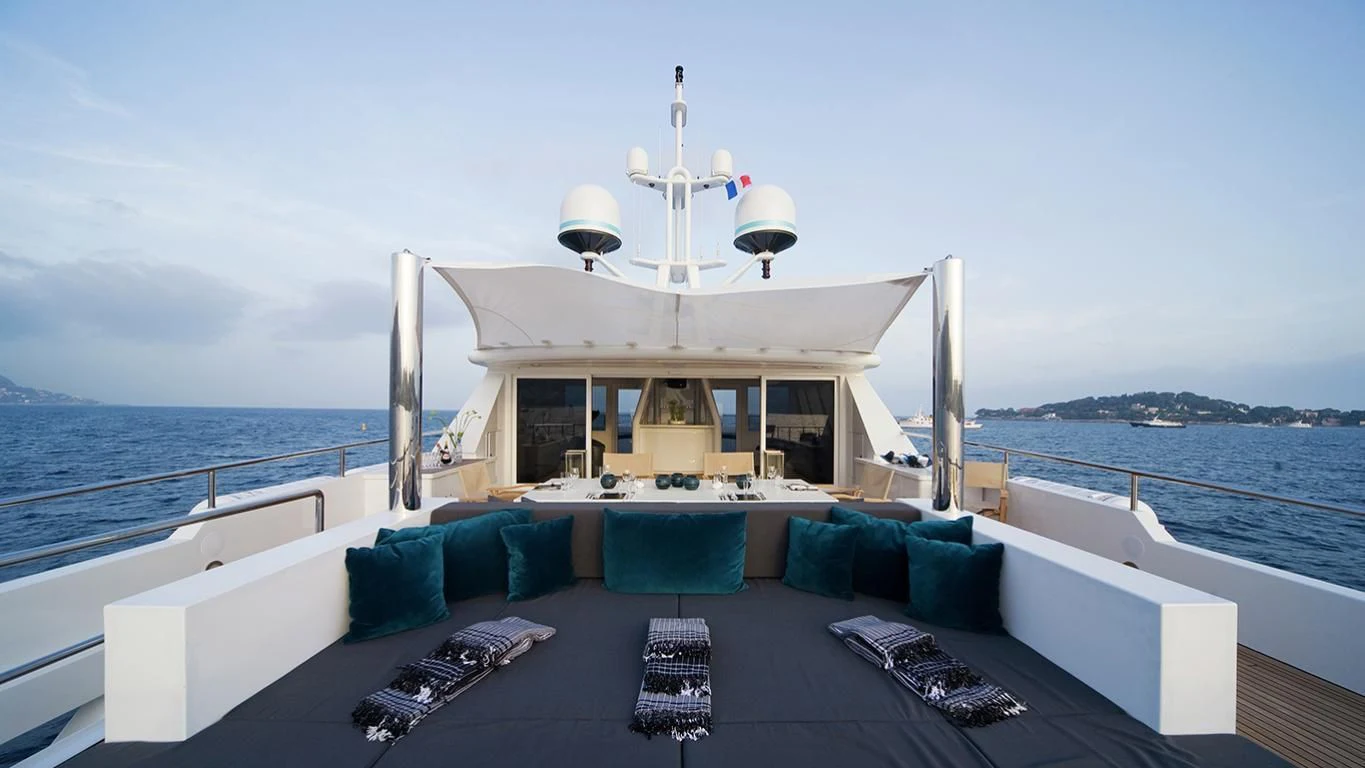 a large white boat on a large body of water aboard CYAN Yacht for Sale