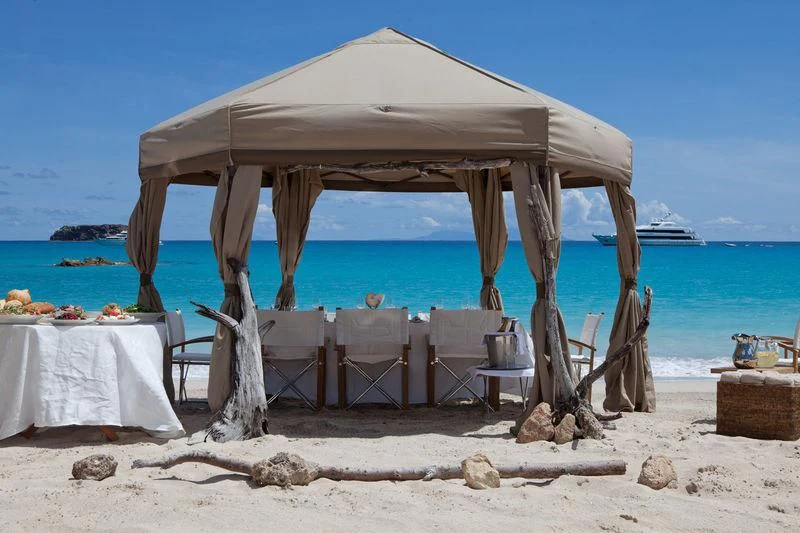 a table and chairs on a beach aboard LADY BRITT Yacht for Charter