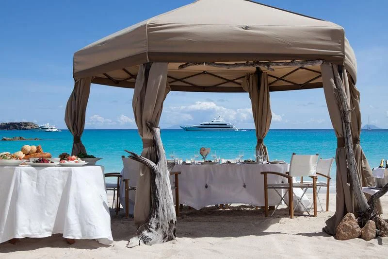 a table and chairs on a beach aboard LADY BRITT Yacht for Charter