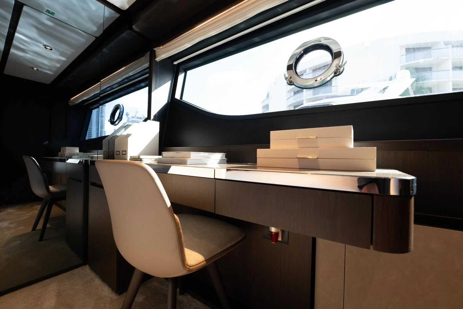a room with a large window and a desk with a large window aboard BESO Yacht for Sale
