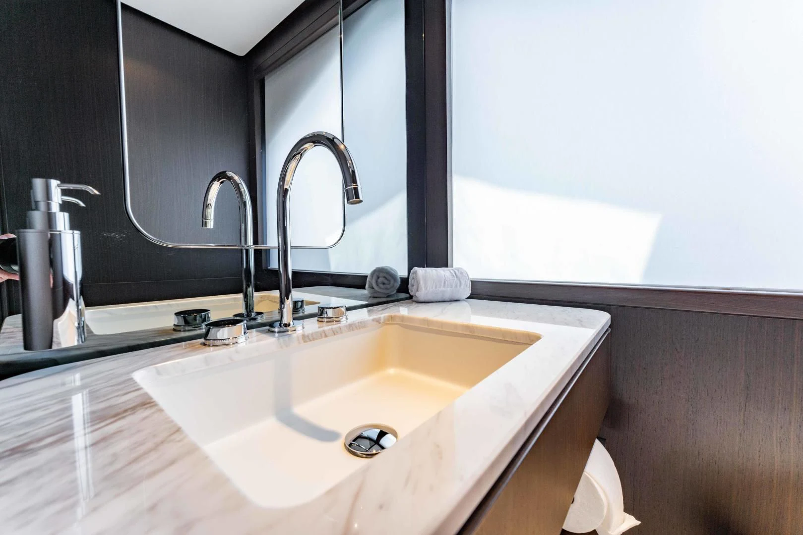 a bathroom with a sink and a mirror aboard BESO Yacht for Sale