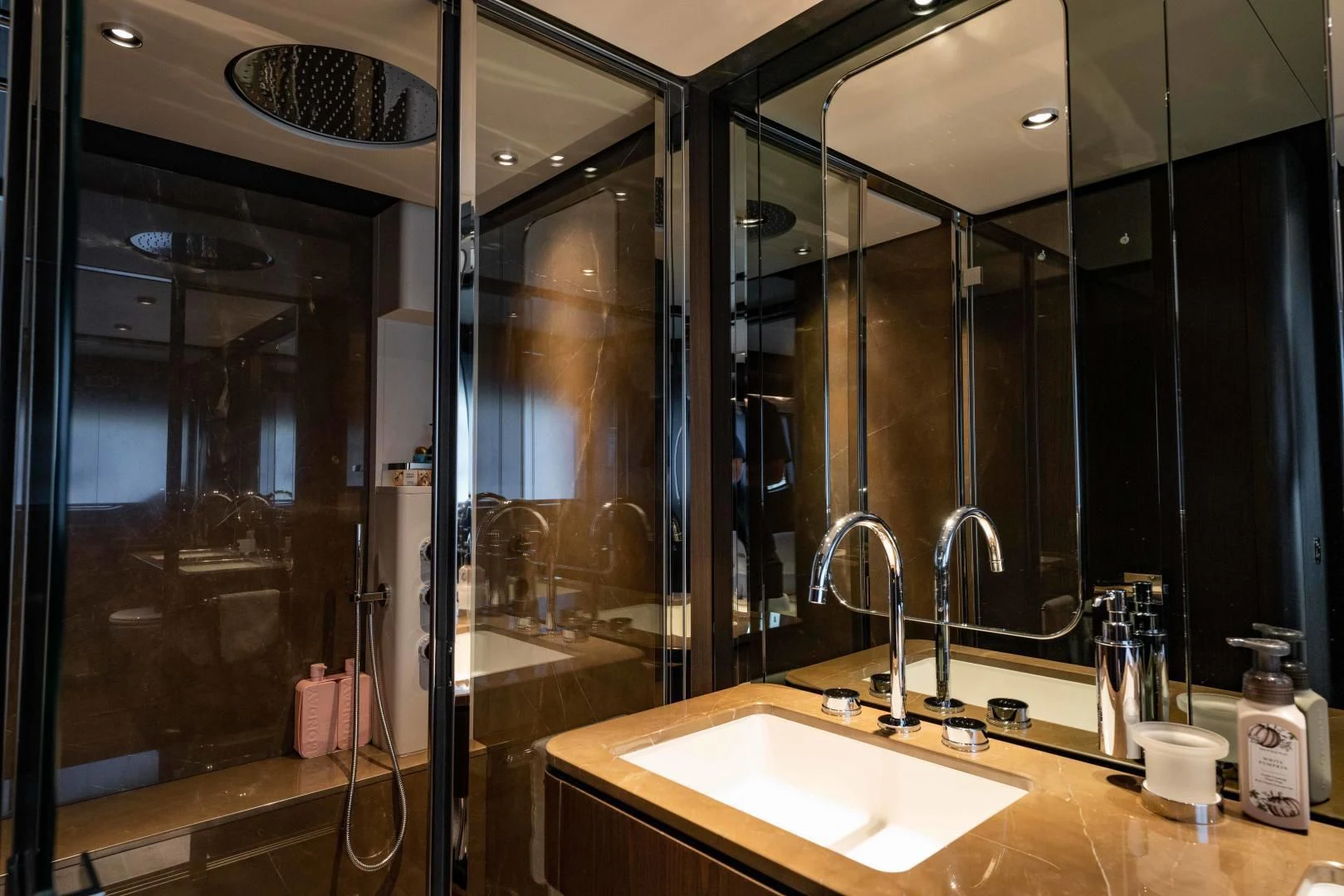 a bathroom with a large mirror aboard BESO Yacht for Sale
