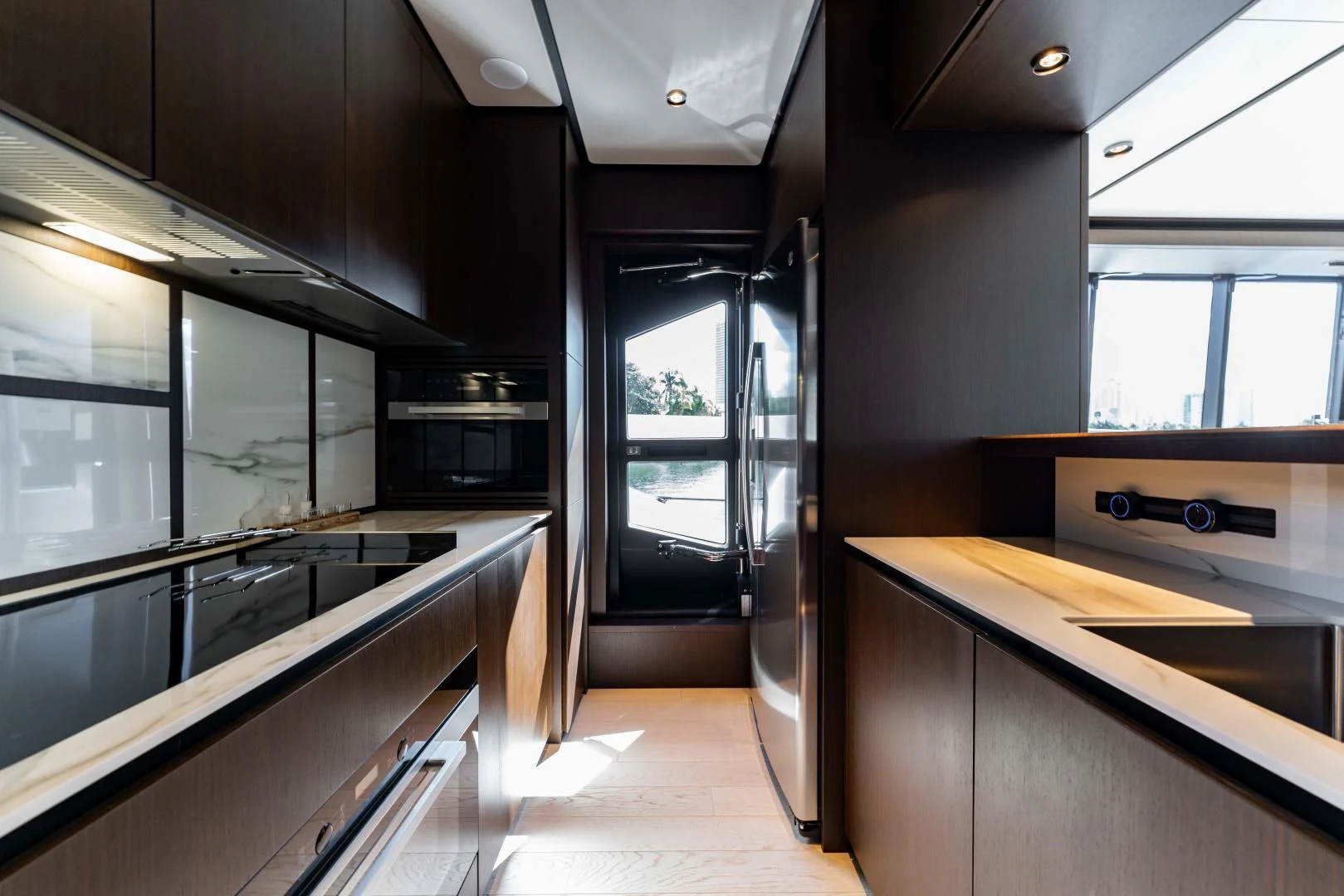 a kitchen with a large glass door aboard BESO Yacht for Sale