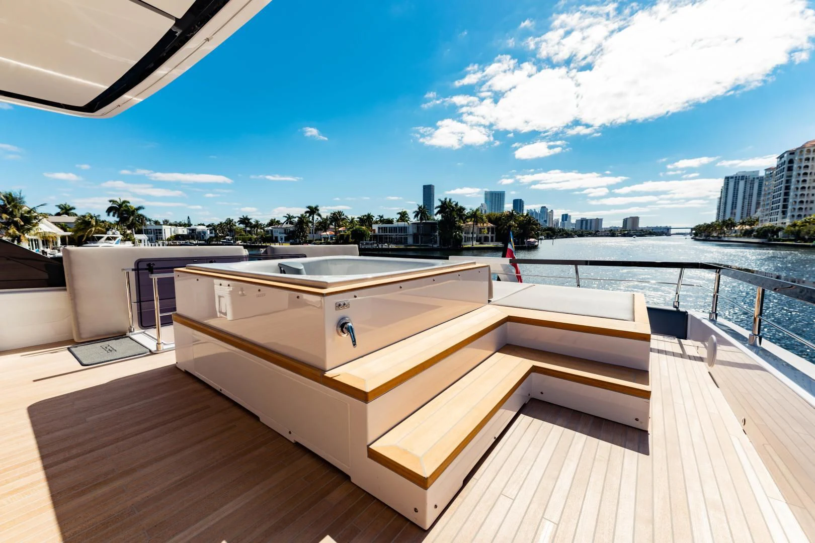 a deck with a view of a city and water aboard BESO Yacht for Sale