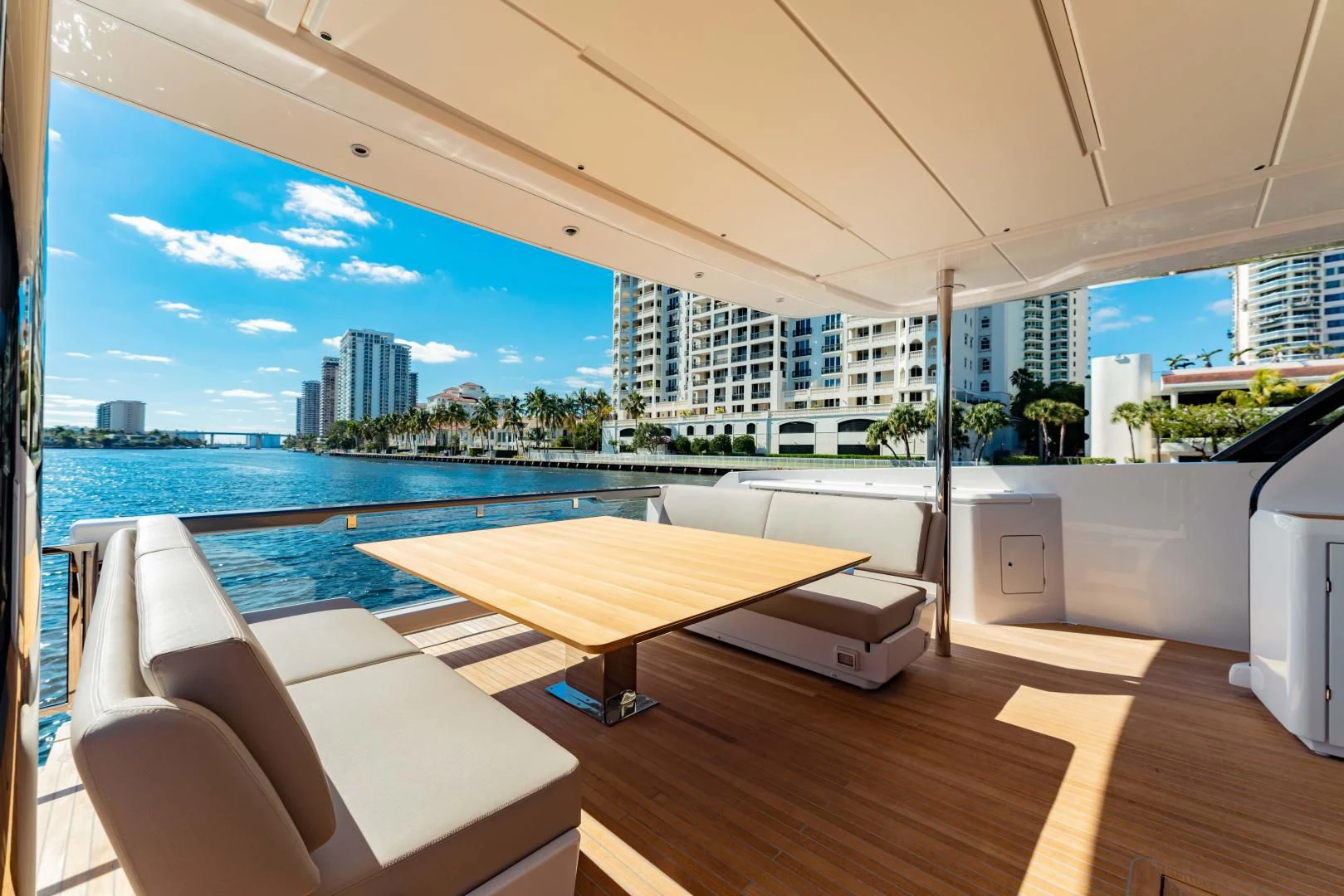 a room with a table and chairs and a view of the water aboard BESO Yacht for Sale