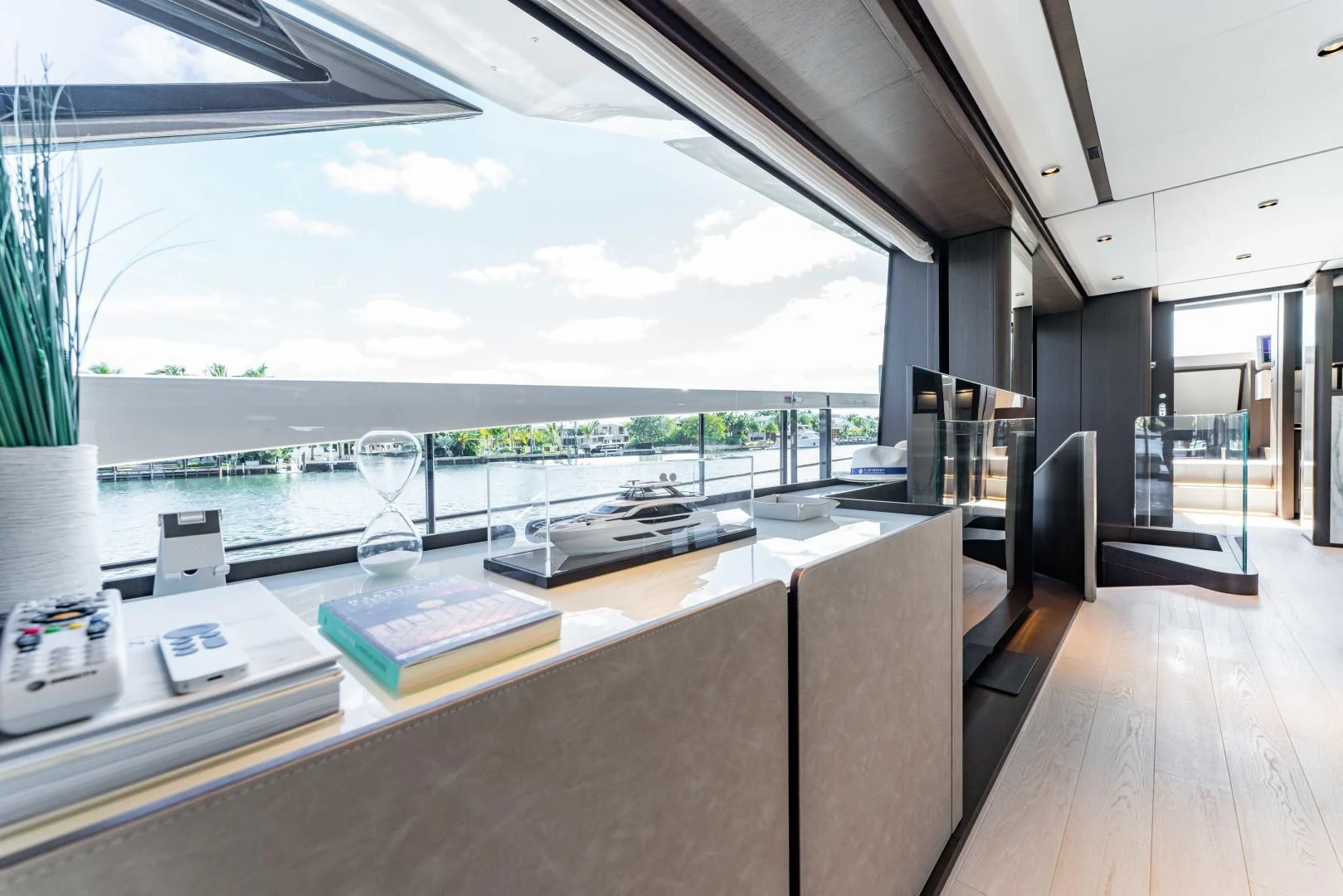 a room with a large window and a table with chairs and a view of the water aboard BESO Yacht for Sale