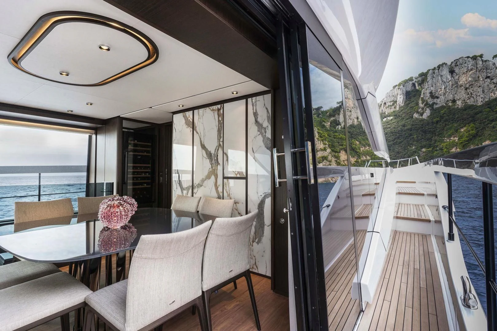 a deck with a view of the mountains and the ocean aboard BESO Yacht for Sale
