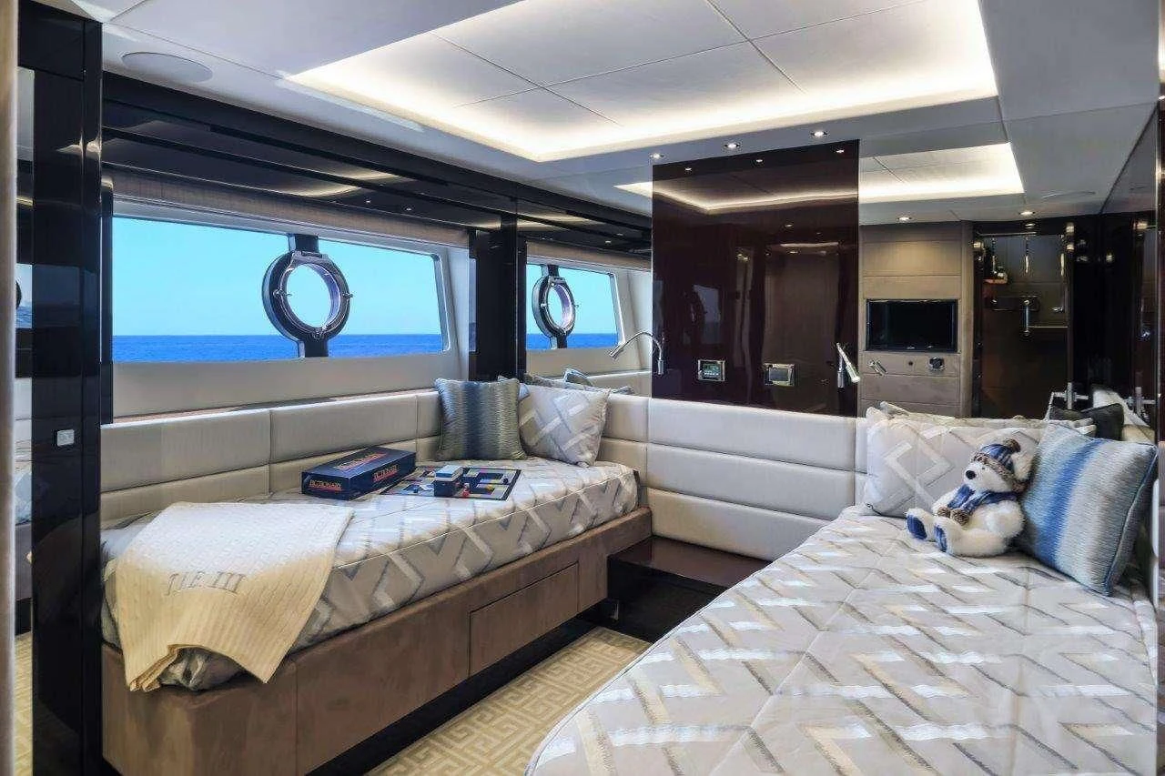 a room with beds and a tv aboard GOLDEN OURS Yacht for Sale