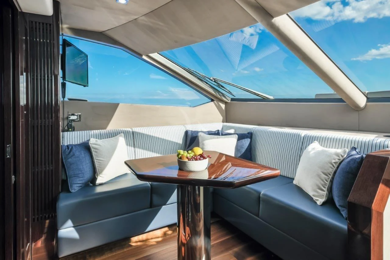 a room with a table and a couch aboard GOLDEN OURS Yacht for Sale