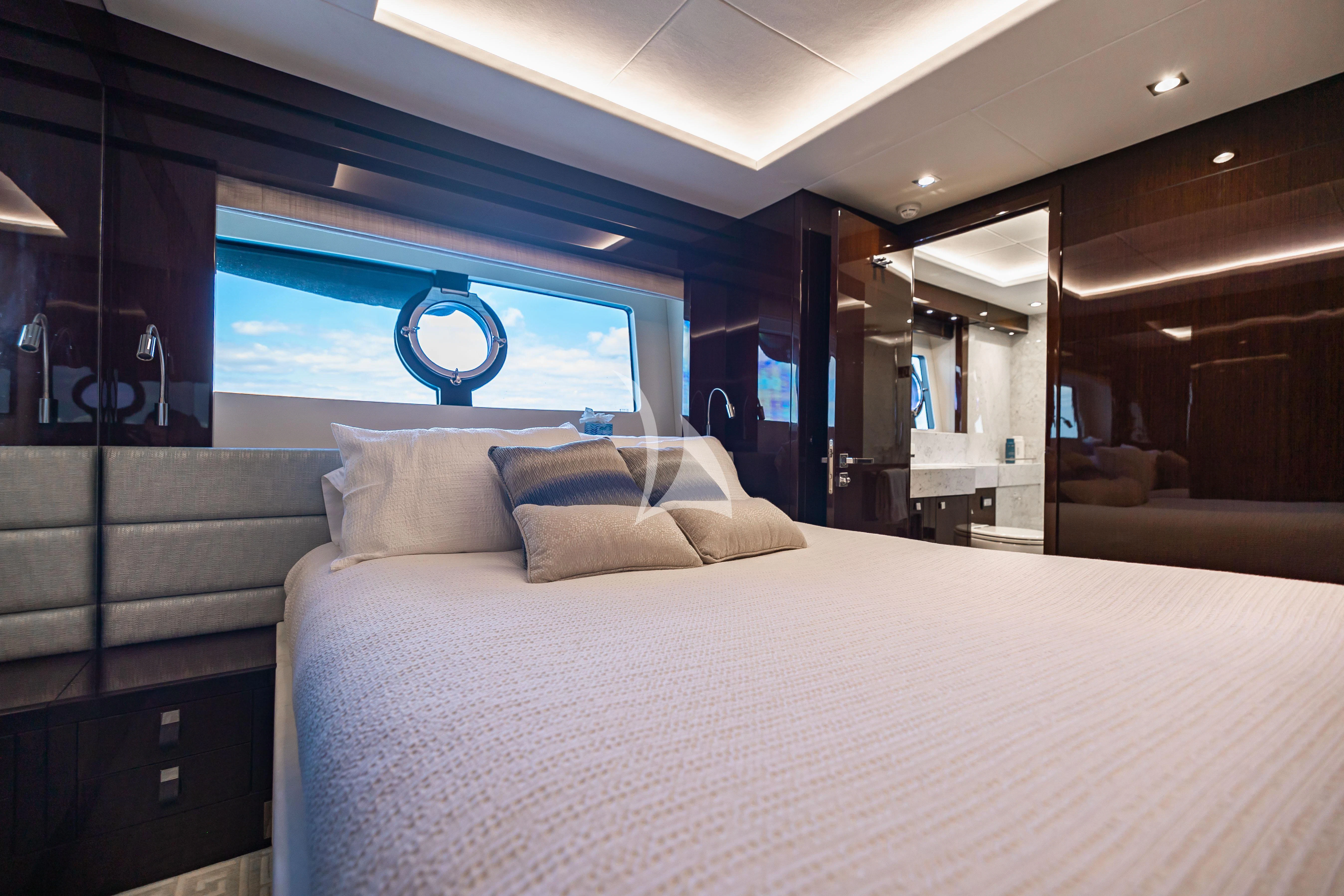 a bed with a white bed spread aboard GOLDEN OURS Yacht for Sale