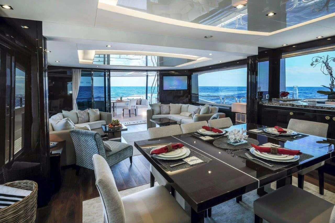 a large room with a table and chairs aboard GOLDEN OURS Yacht for Sale