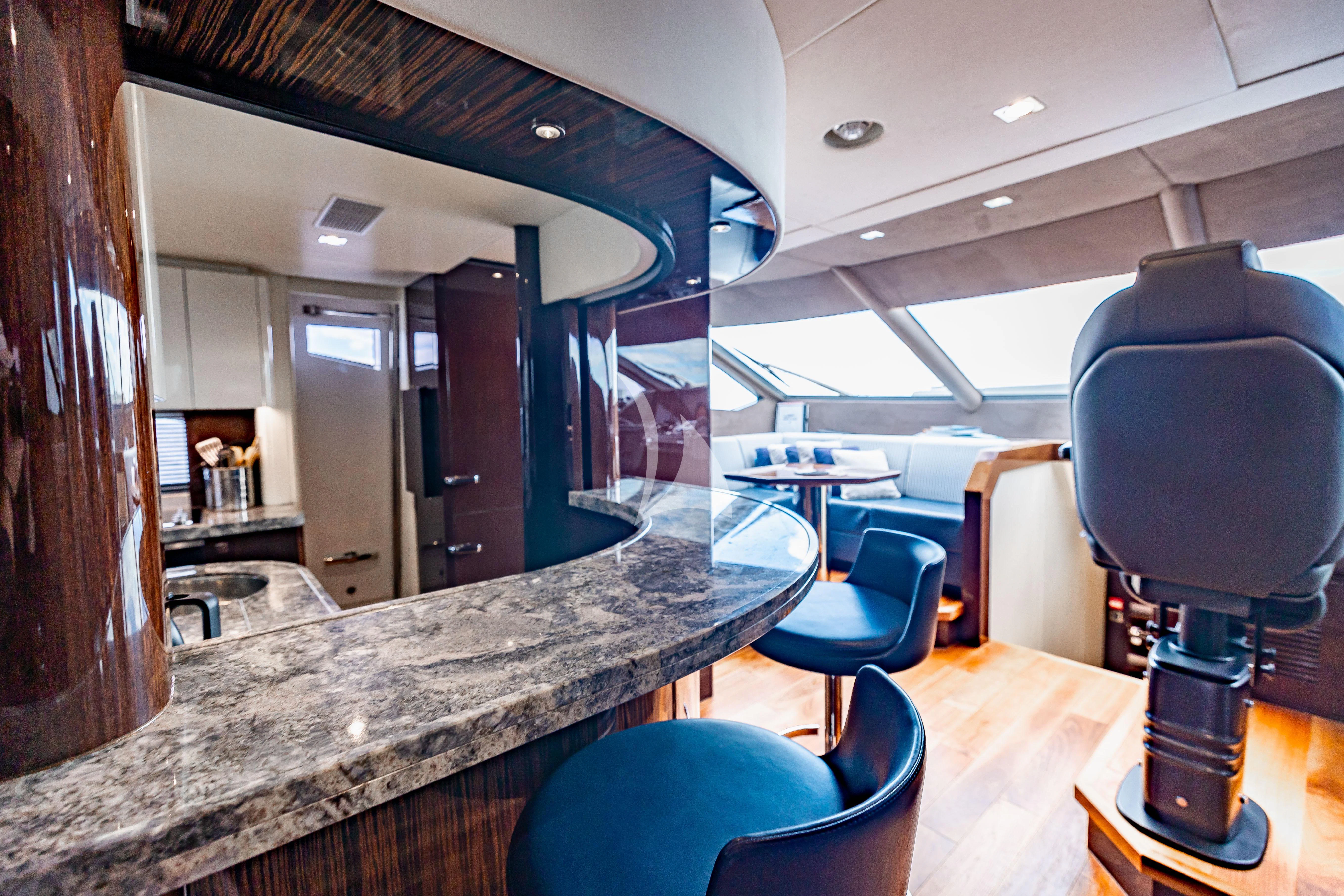 a room with a table chairs and a large window aboard GOLDEN OURS Yacht for Sale