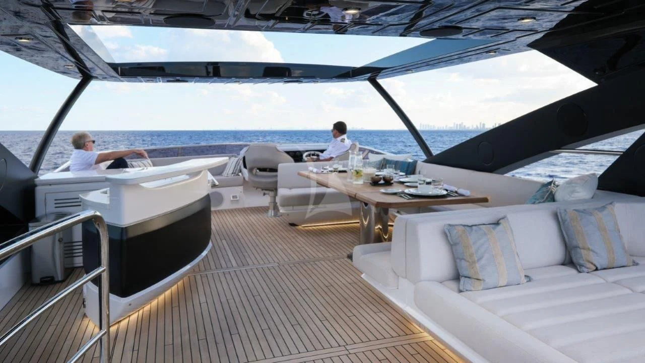 a boat with a table and chairs aboard GOLDEN OURS Yacht for Sale