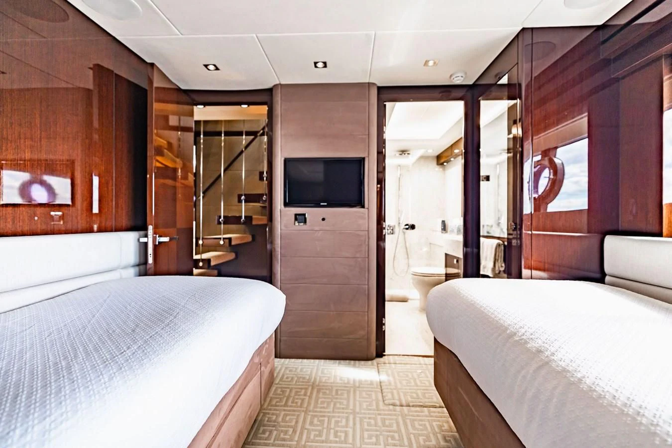 a room with a bed and a television aboard GOLDEN OURS Yacht for Sale
