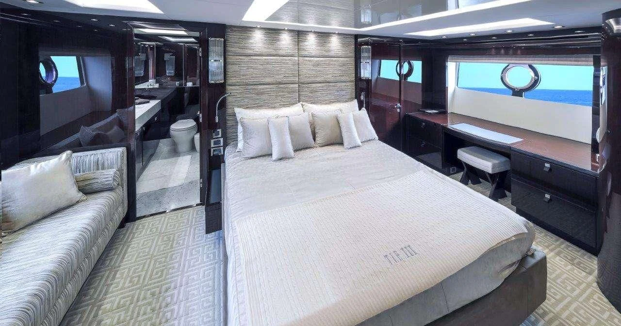 a room with a bed and a desk aboard GOLDEN OURS Yacht for Sale