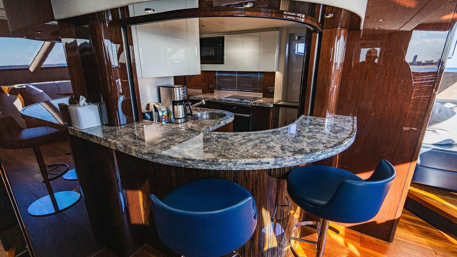 a kitchen with a bar and a table aboard GOLDEN OURS Yacht for Sale