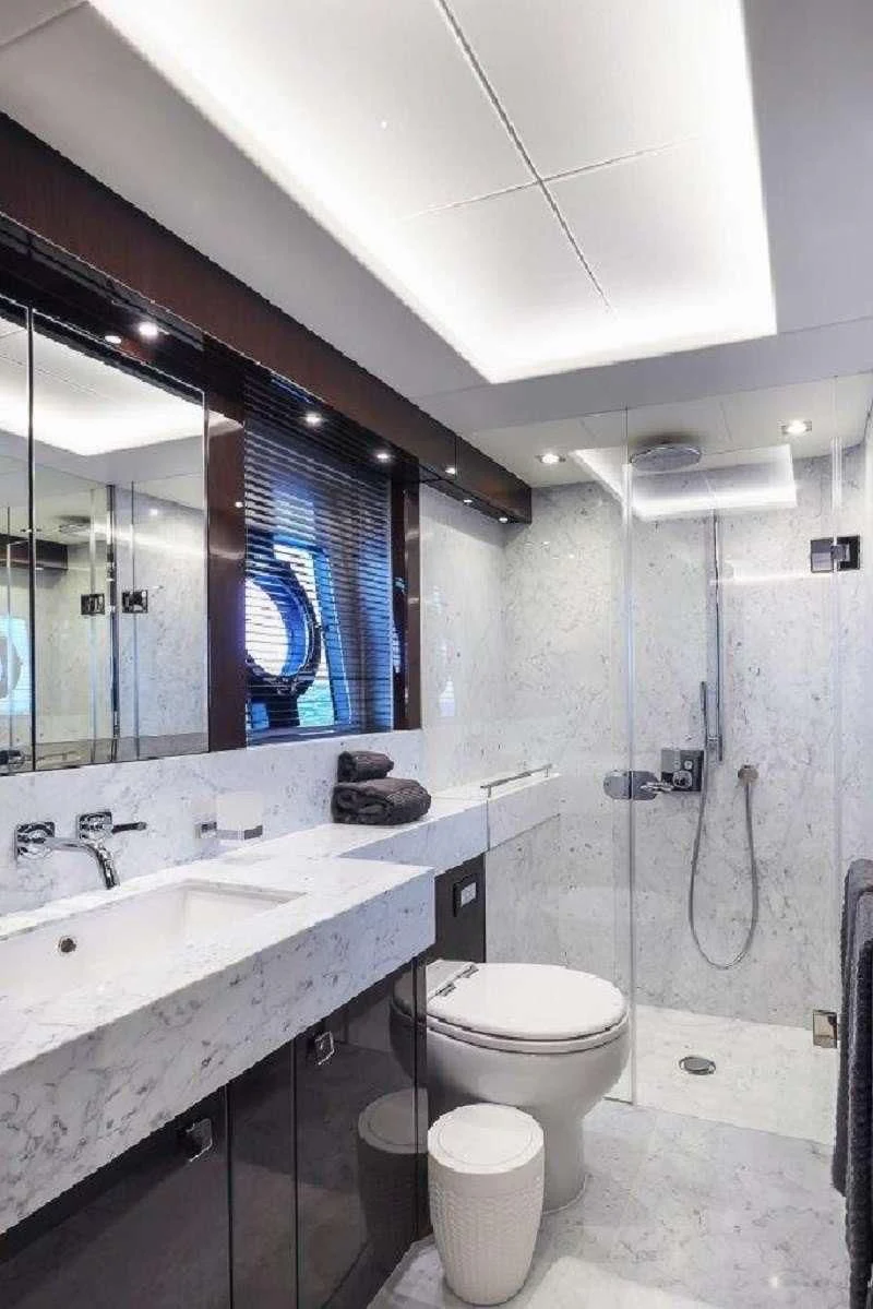 a bathroom with a sink toilet and a mirror aboard GOLDEN OURS Yacht for Sale