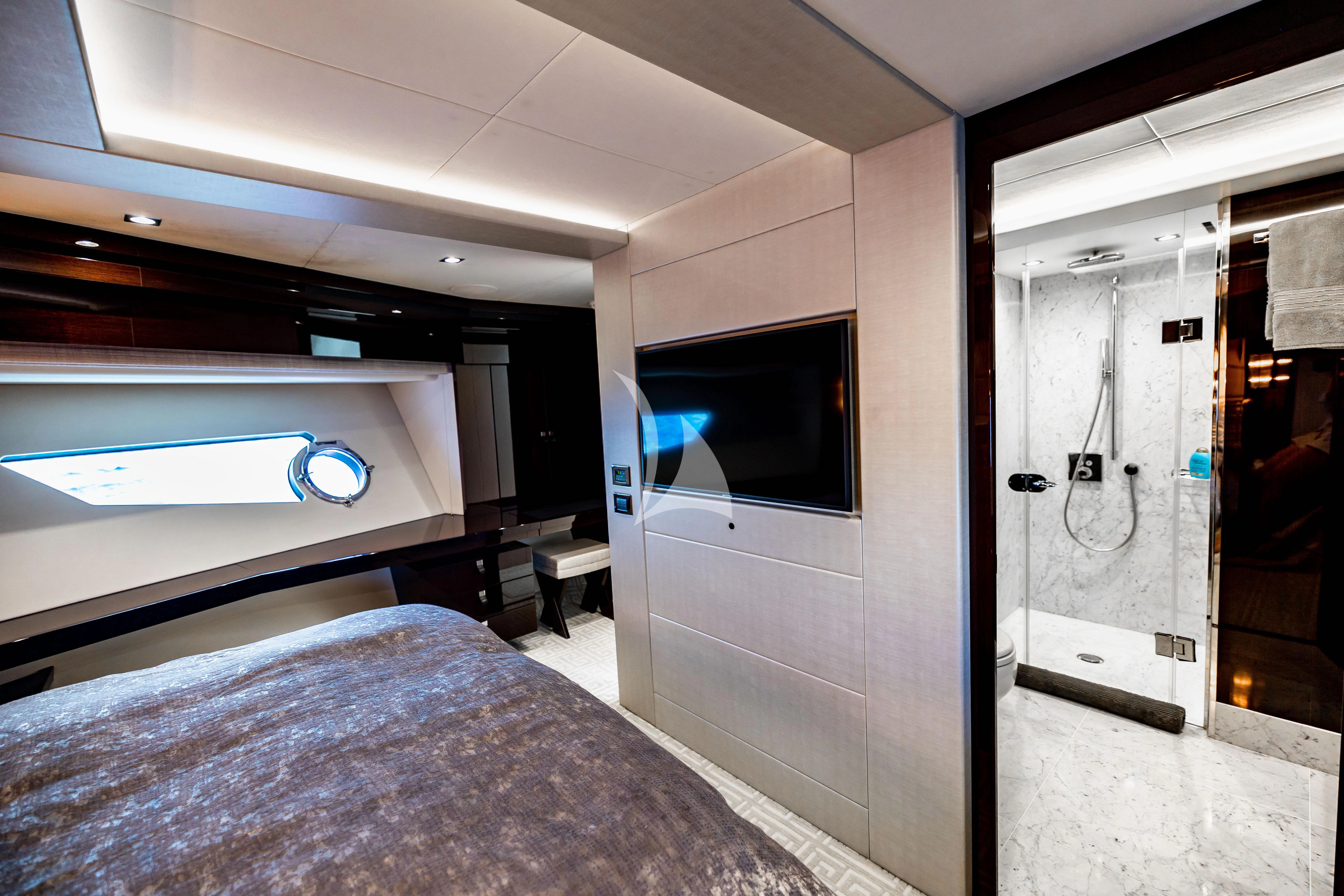 a room with a bed and a tv on the wall aboard GOLDEN OURS Yacht for Sale