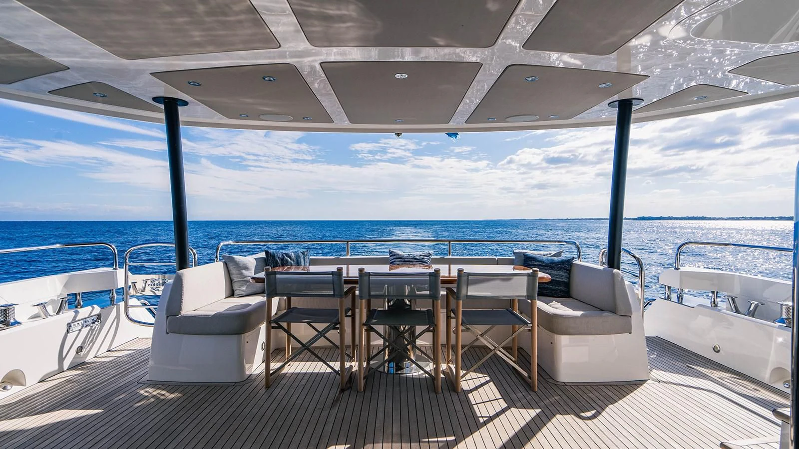 a deck with chairs and tables on it aboard GOLDEN OURS Yacht for Sale