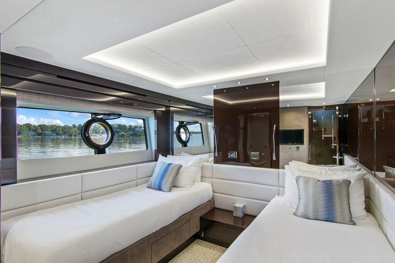 a room with a bed and a large window aboard GOLDEN OURS Yacht for Sale