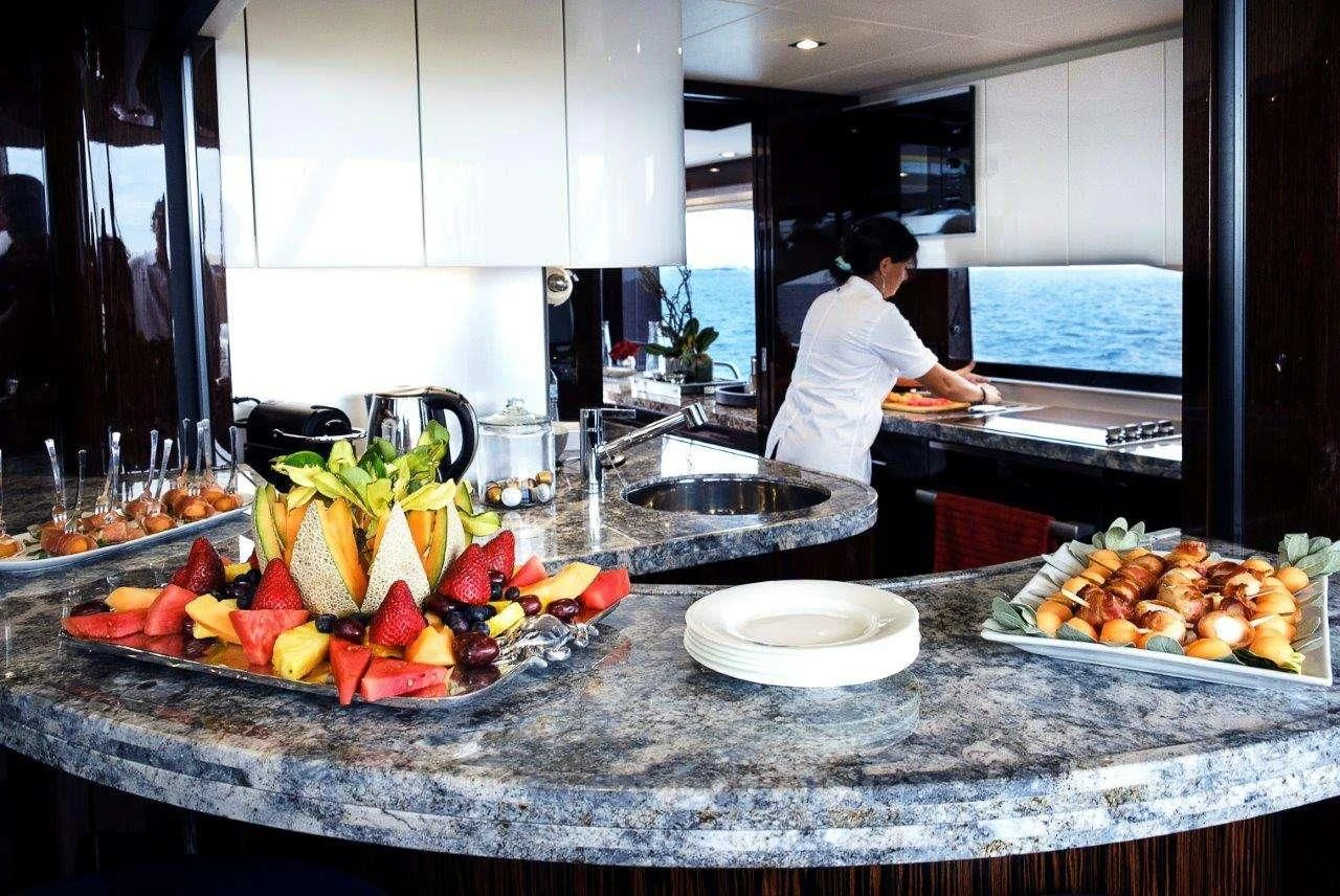 a chef preparing food in a kitchen aboard GOLDEN OURS Yacht for Sale