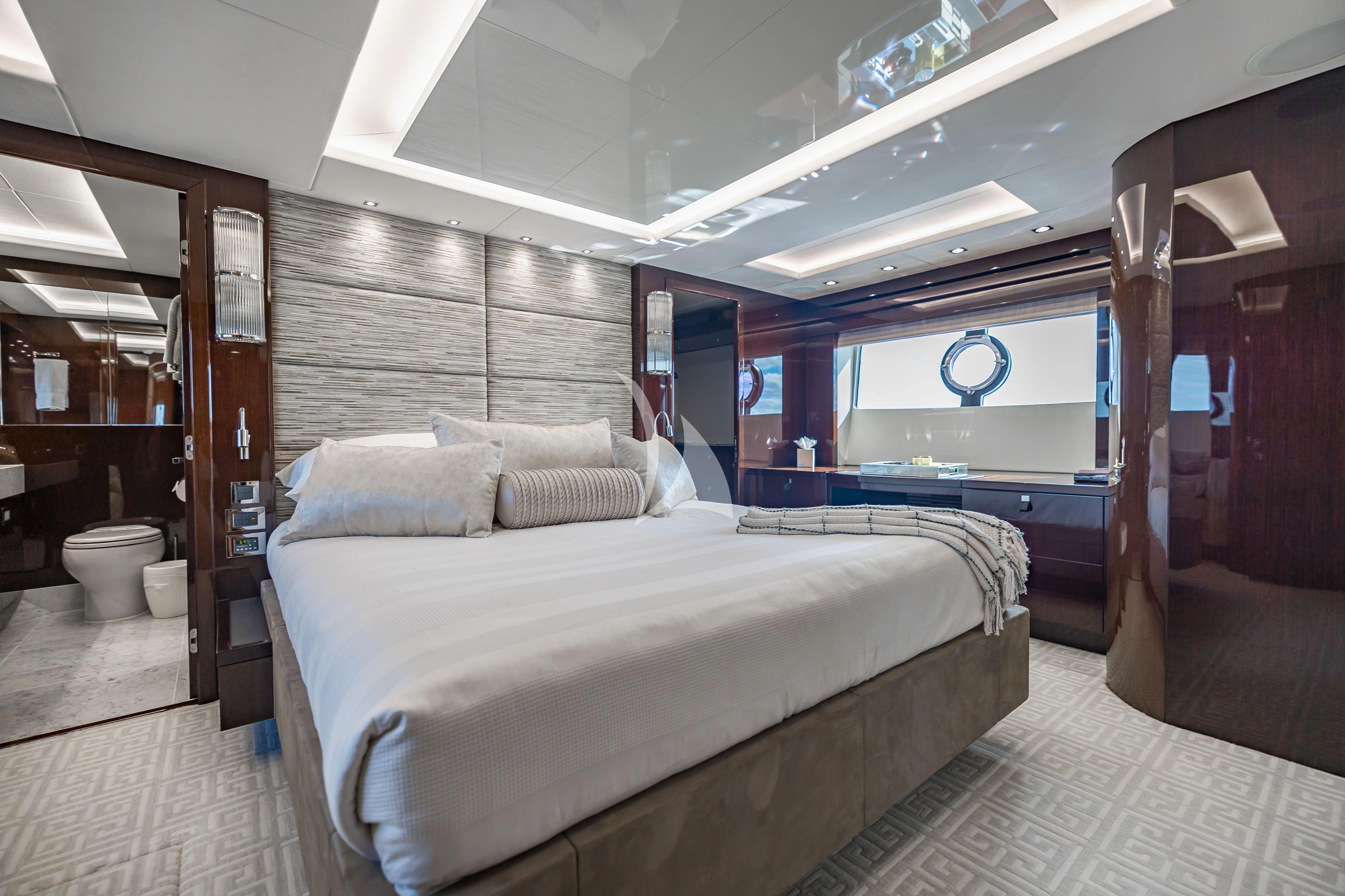 a room with a bed and a mirror aboard GOLDEN OURS Yacht for Sale