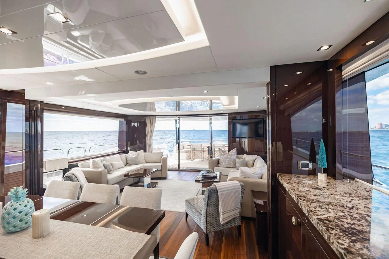 a living room with a large balcony aboard GOLDEN OURS Yacht for Sale