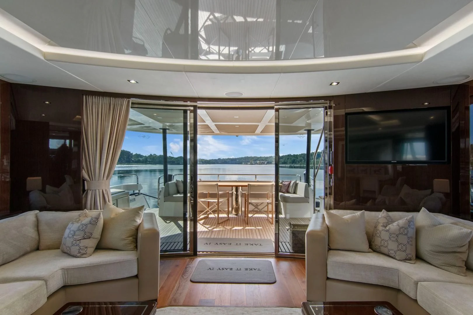 a living room with a view of the ocean aboard GOLDEN OURS Yacht for Sale