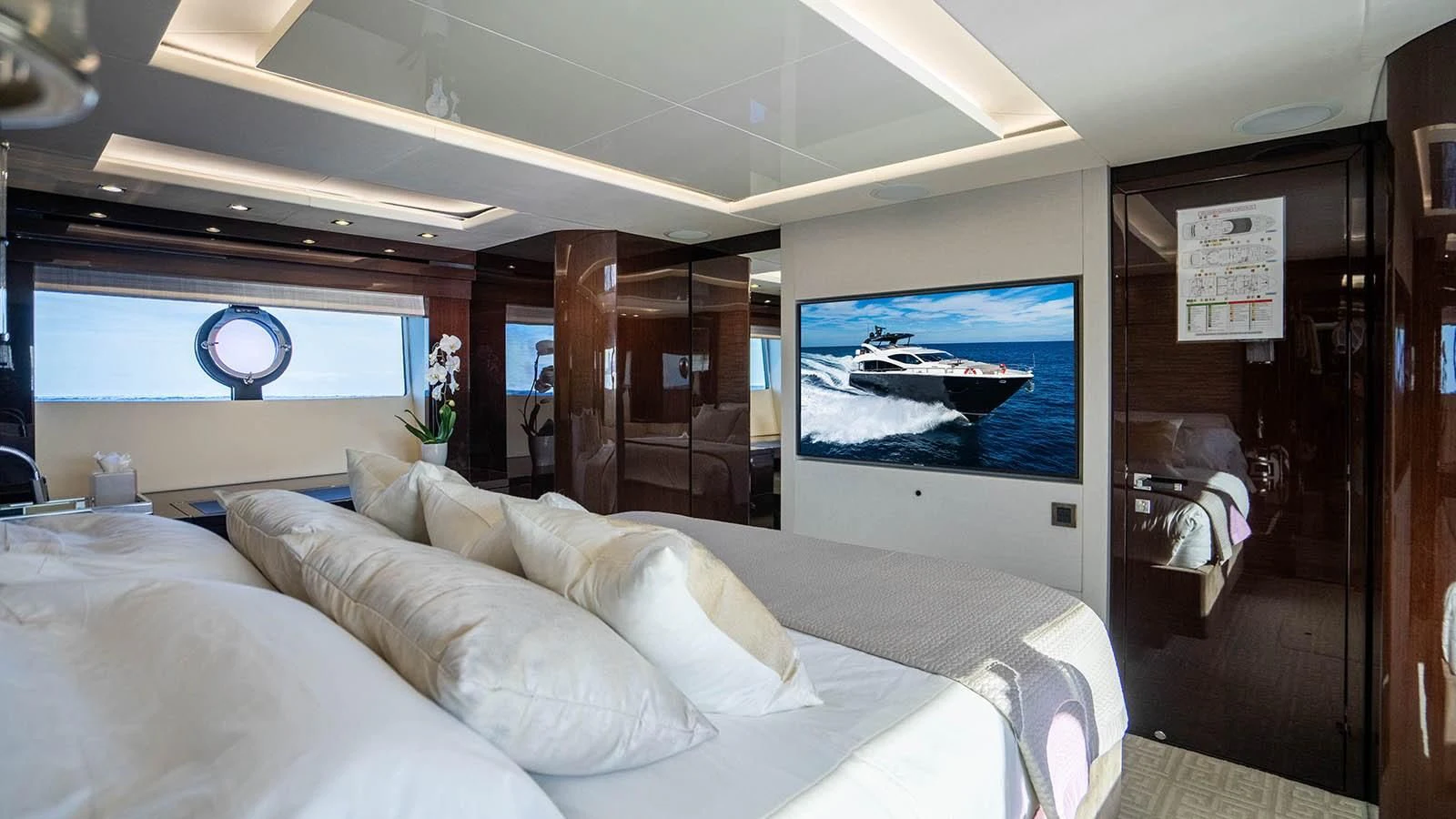 a room with a bed and a television aboard GOLDEN OURS Yacht for Sale