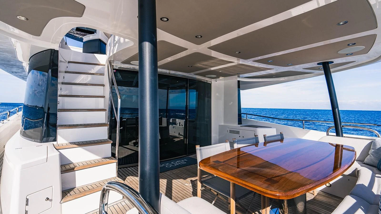 a boat with a table and chairs aboard GOLDEN OURS Yacht for Sale