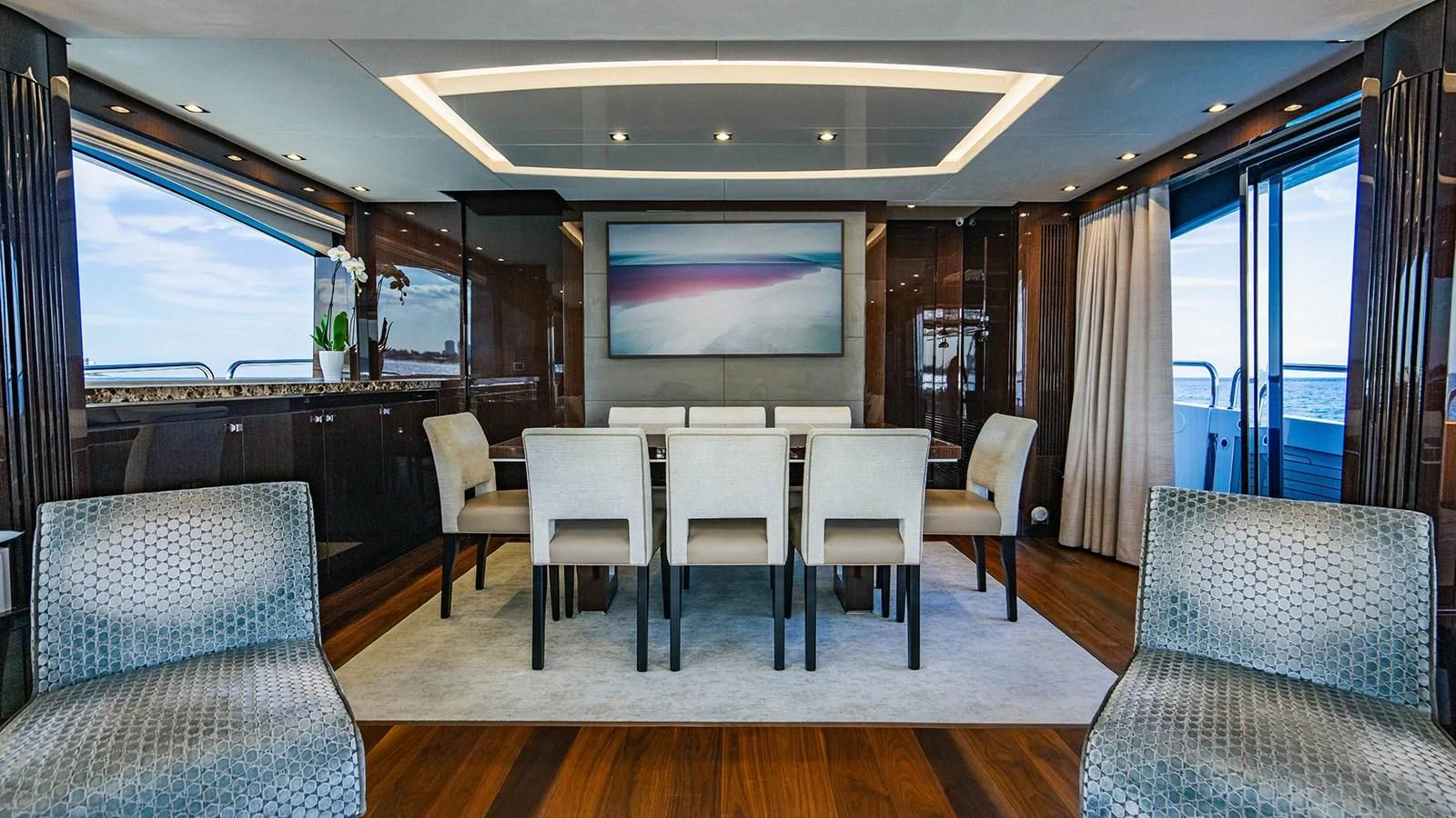 a room with a table chairs and a tv aboard GOLDEN OURS Yacht for Sale