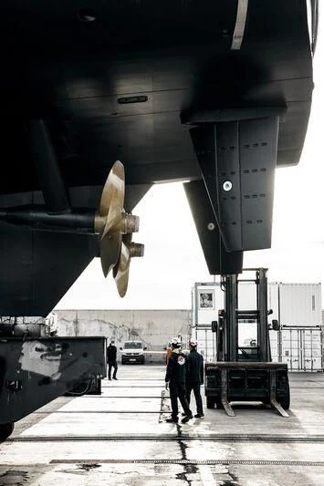 a group of people standing next to a jet aboard GALAXY Yacht for Sale