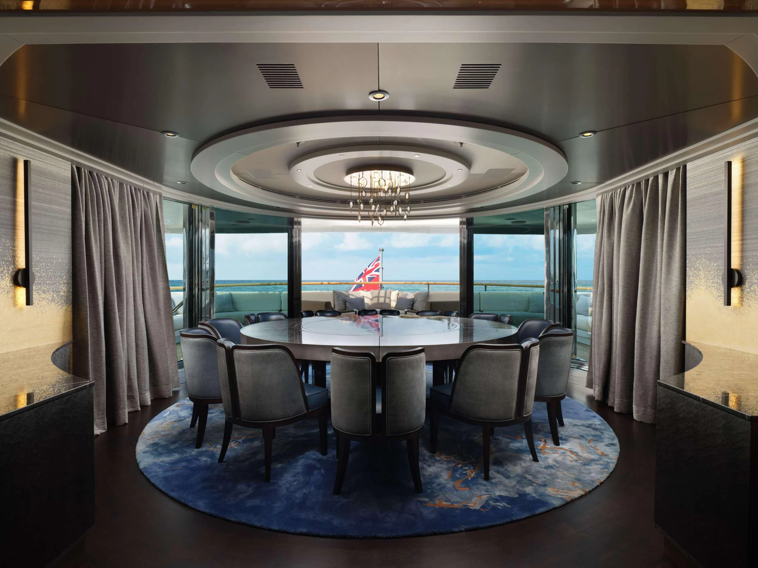 a large room with a table and chairs aboard GALAXY Yacht for Sale