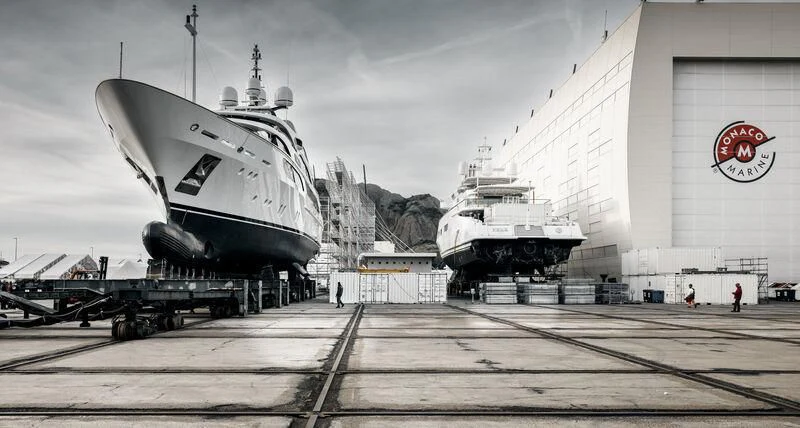 a large military ship docked aboard GALAXY Yacht for Sale