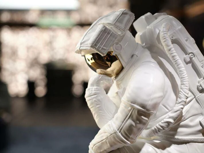 a person in a white suit and gloves holding a white object aboard GALAXY Yacht for Sale
