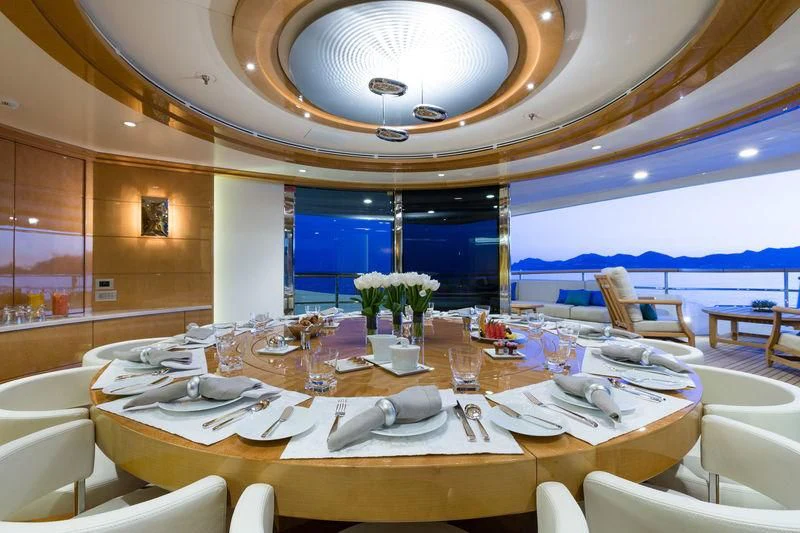 a large room with tables and chairs aboard GALAXY Yacht for Sale