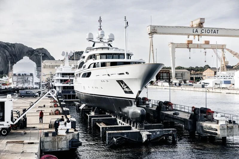 a large white boat sits in a harbor aboard GALAXY Yacht for Sale