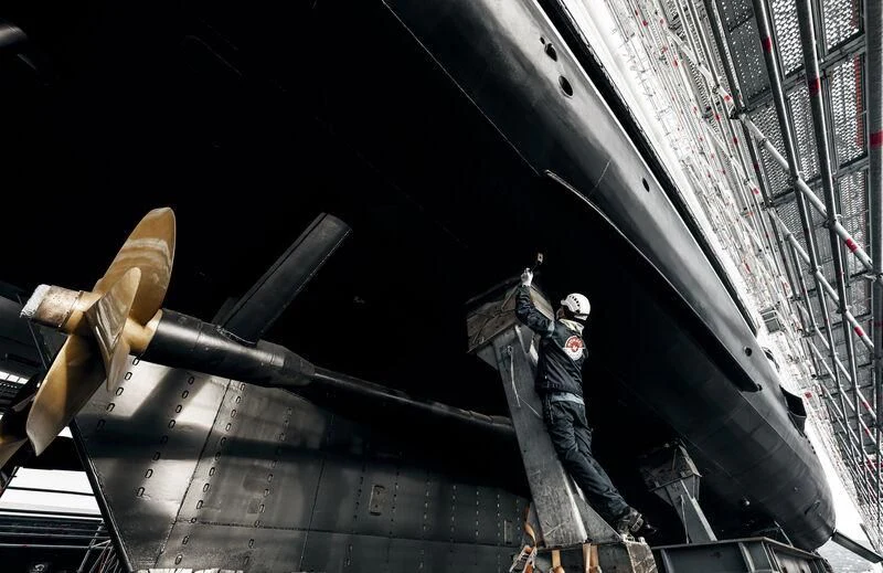 a man standing next to a large metal object with a sword aboard GALAXY Yacht for Sale
