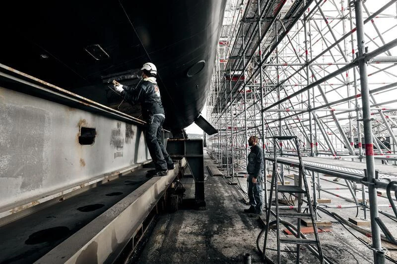 a few men working on a machine aboard GALAXY Yacht for Sale