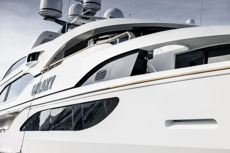 a white yacht with black stripes aboard GALAXY Yacht for Sale