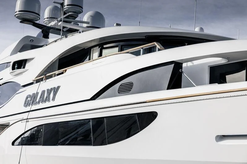 a white yacht with a black stripe aboard GALAXY Yacht for Sale