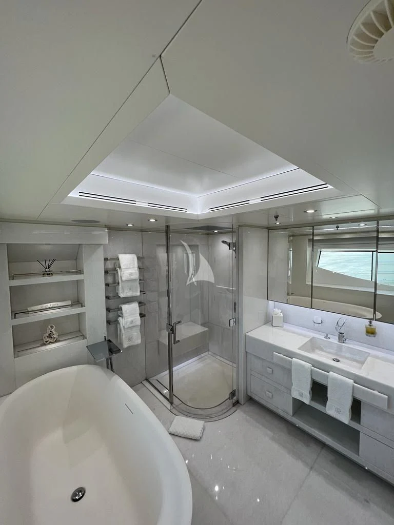 a bathroom with a tub sink and a shower aboard GALAXY Yacht for Sale