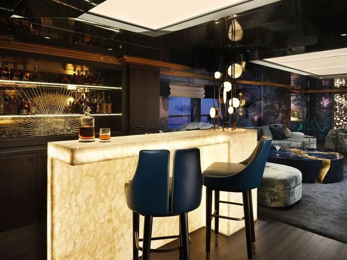 a bar with a bar and chairs aboard GALAXY Yacht for Sale