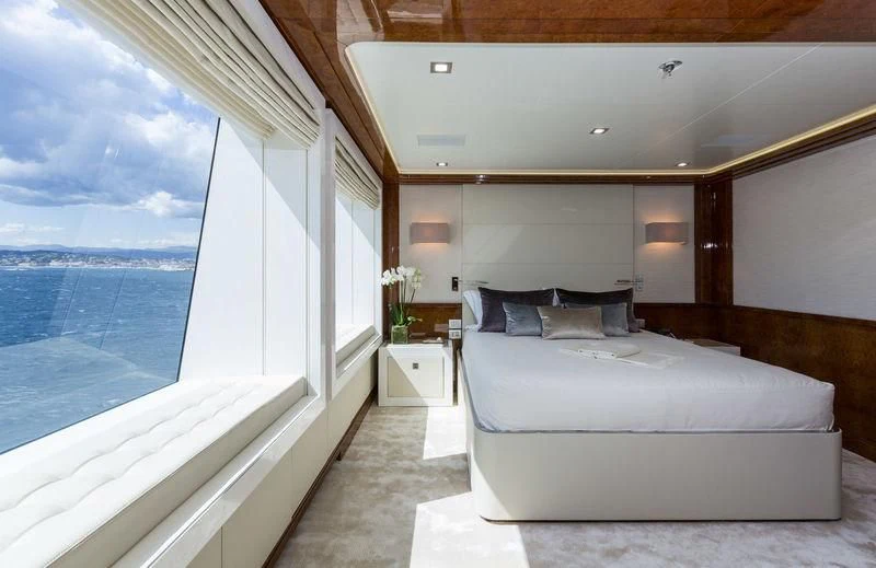 a room with a bed and a window aboard GALAXY Yacht for Sale