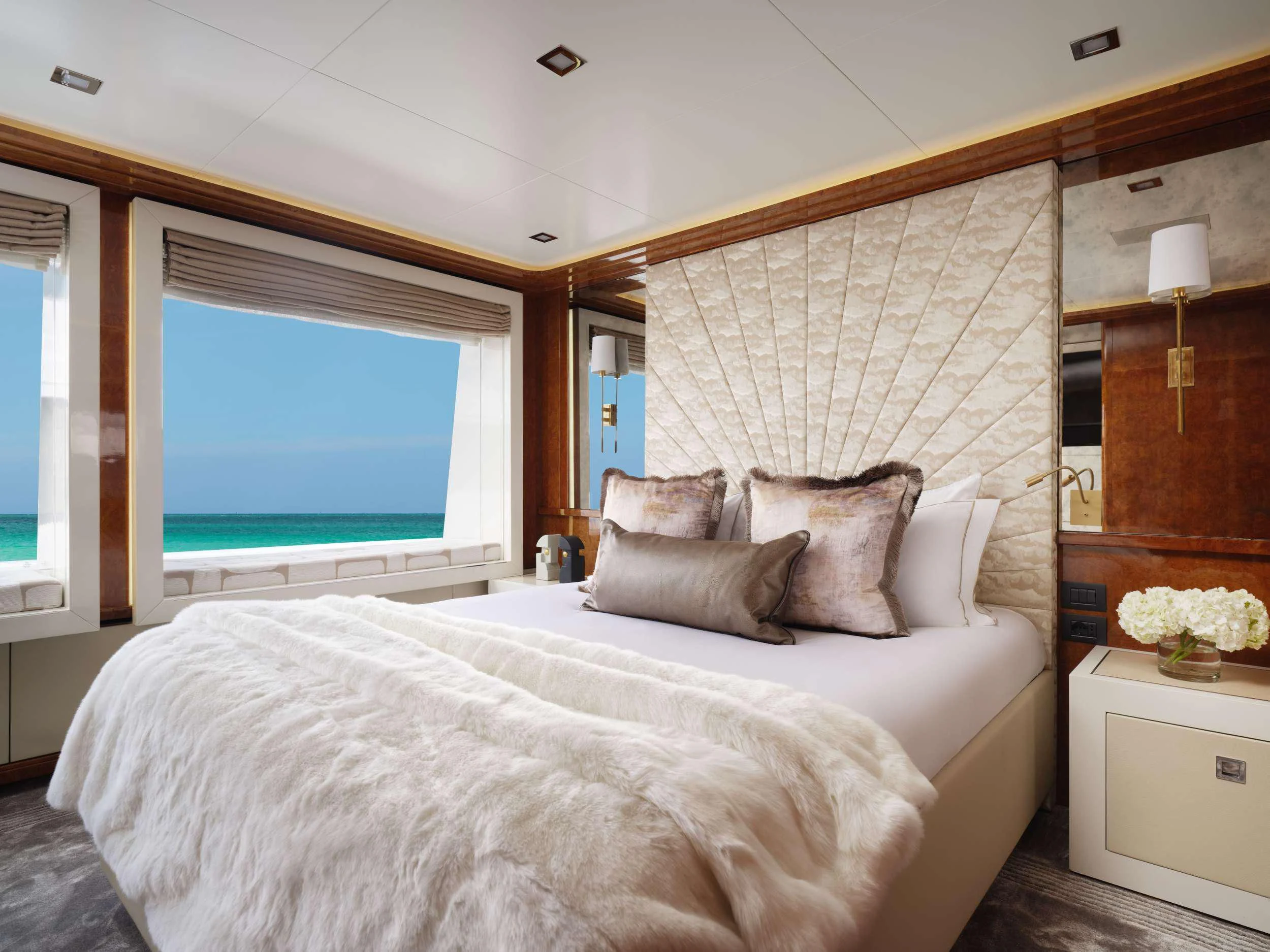 a bed with a white bed spread aboard GALAXY Yacht for Sale
